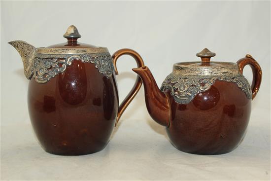 Wedgwood treacle glazed pottery silver mounted part tea set, c.1906, the hot water pot 13cm., one plate broken (13)(-)